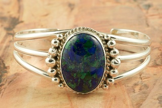 Genuine Azurite set in Sterling Silver Bracelet. Azurite is mined at the Nevada Lode Mine, San Juan County, Utah. Created by Navajo Artist Justin Morris. Signed by the artist. Justin Morris incorporates meaning in his Sterling Silver Designs. The Sterling Silver Raindrops represent Abundance.